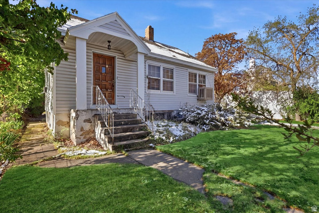 Light-colored siding exterior with an inviting covered porch entry