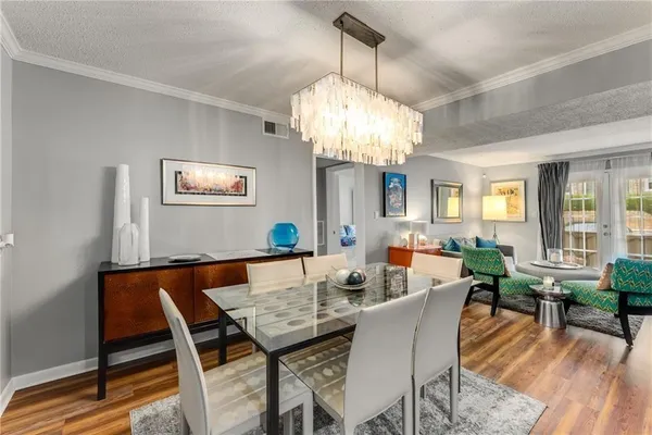 a view of a dining room with furniture wooden floor and chandelier