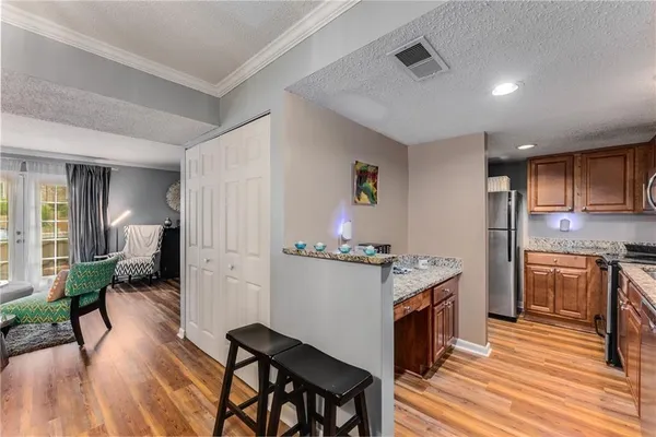 a kitchen with a refrigerator and a stove top oven