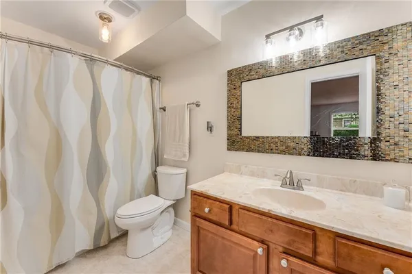a bathroom with a sink a toilet and a mirror