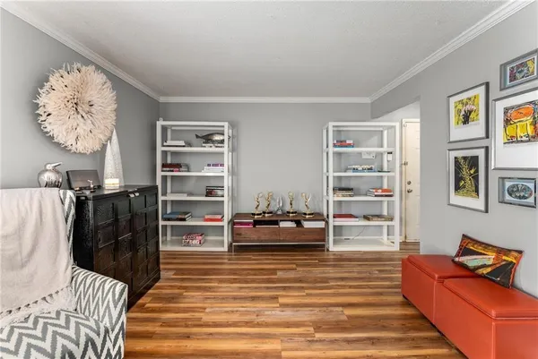 a living room with furniture and a book shelf