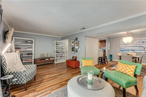 a living room with furniture and a wooden floor