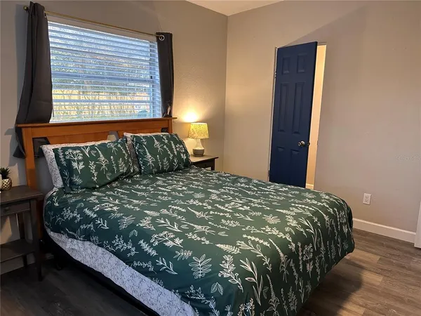 a bed sitting in a bedroom next to a window