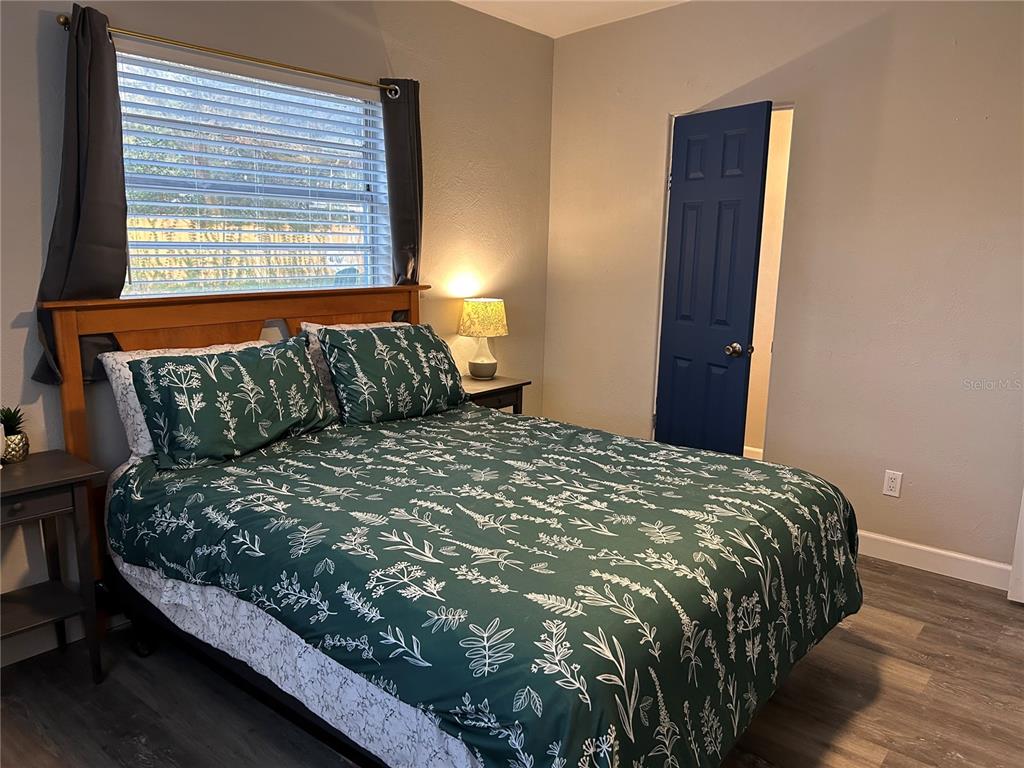 3320 Conway Gardens Road Orlando, FL 32806 - Photo 15 of 21 a bed sitting in a bedroom next to a window