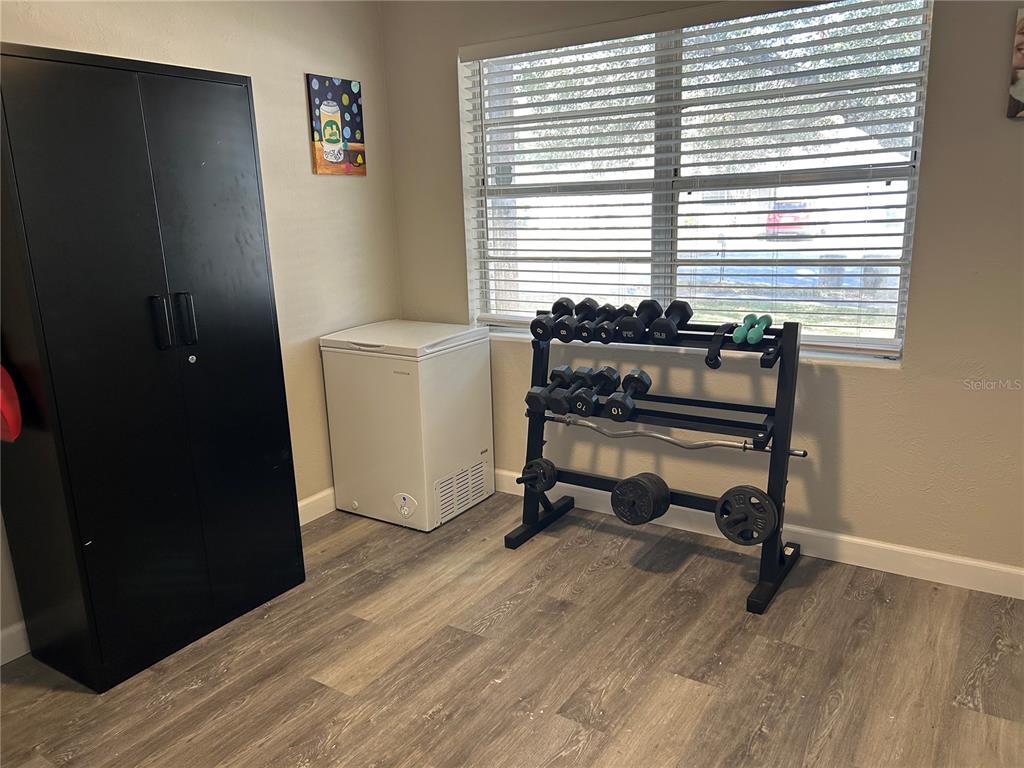 3320 Conway Gardens Road Orlando, FL 32806 - Photo 16 of 21 a view of a workspace with furniture and a window