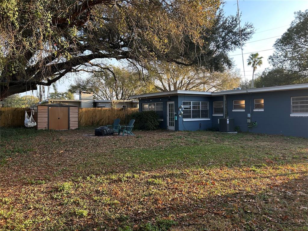 3320 Conway Gardens Road Orlando, FL 32806 - Photo 17 of 21 a view of a house with a yard and a large tree