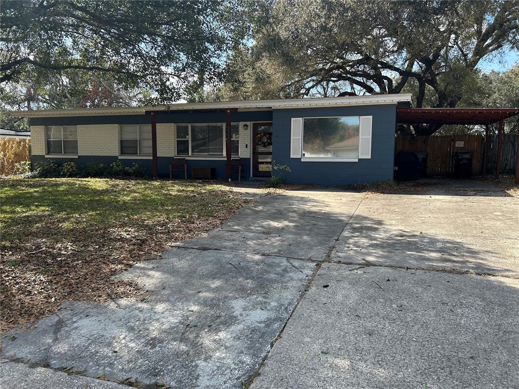 3320 Conway Gardens Road Orlando, FL 32806 - Photo 2 of 21 a front view of a house with a yard and garage