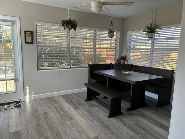 a room with wooden floor and windows