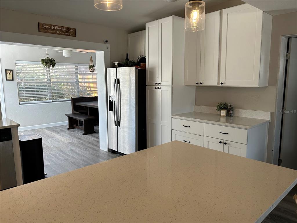 3320 Conway Gardens Road Orlando, FL 32806 - Photo 7 of 21 a kitchen with stainless steel appliances a refrigerator sink and cabinets