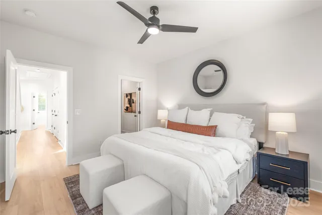 a bedroom with a bed and a chandelier