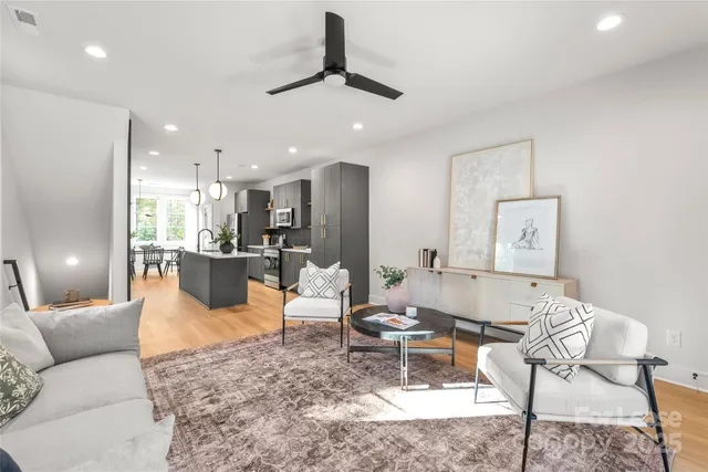 a living room with furniture and kitchen view