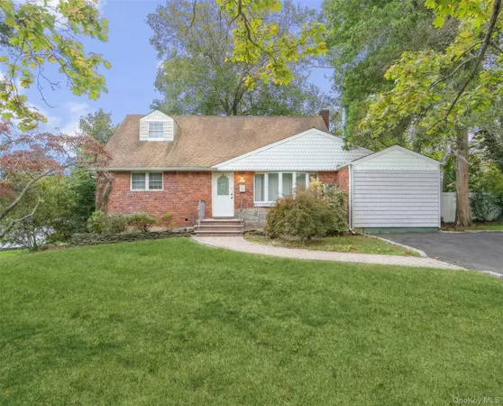 a front view of a house with a garden and plants