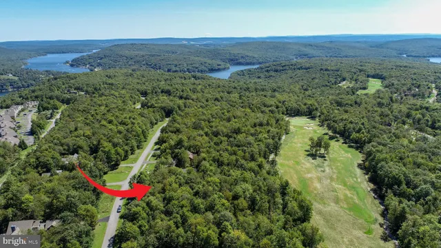 an aerial view of a red house with a yard