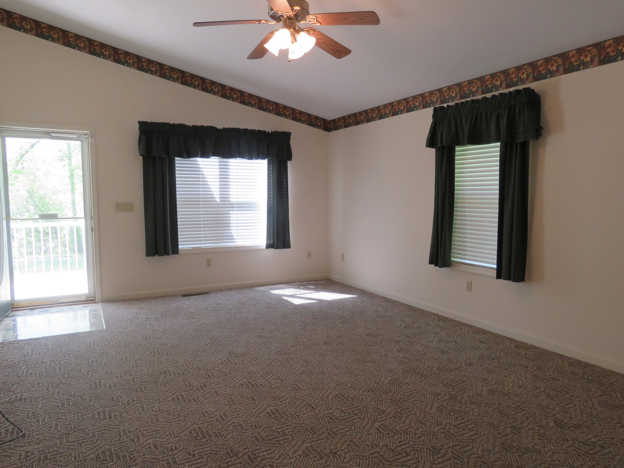 751 Yonside Drive Sparta, TN 38583 - Photo 4 of 36 en empty room with windows and chandelier fan