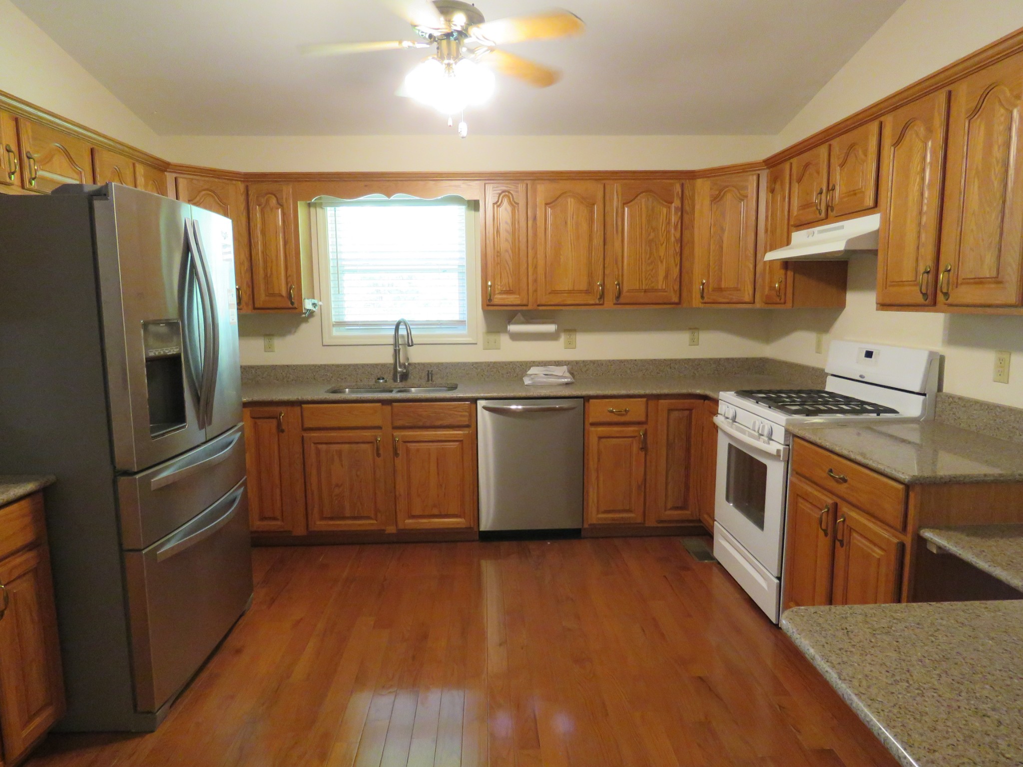 751 Yonside Drive Sparta, TN 38583 - Photo 6 of 36 a kitchen with stainless steel appliances granite countertop a stove a sink dishwasher a refrigerator and a microwave