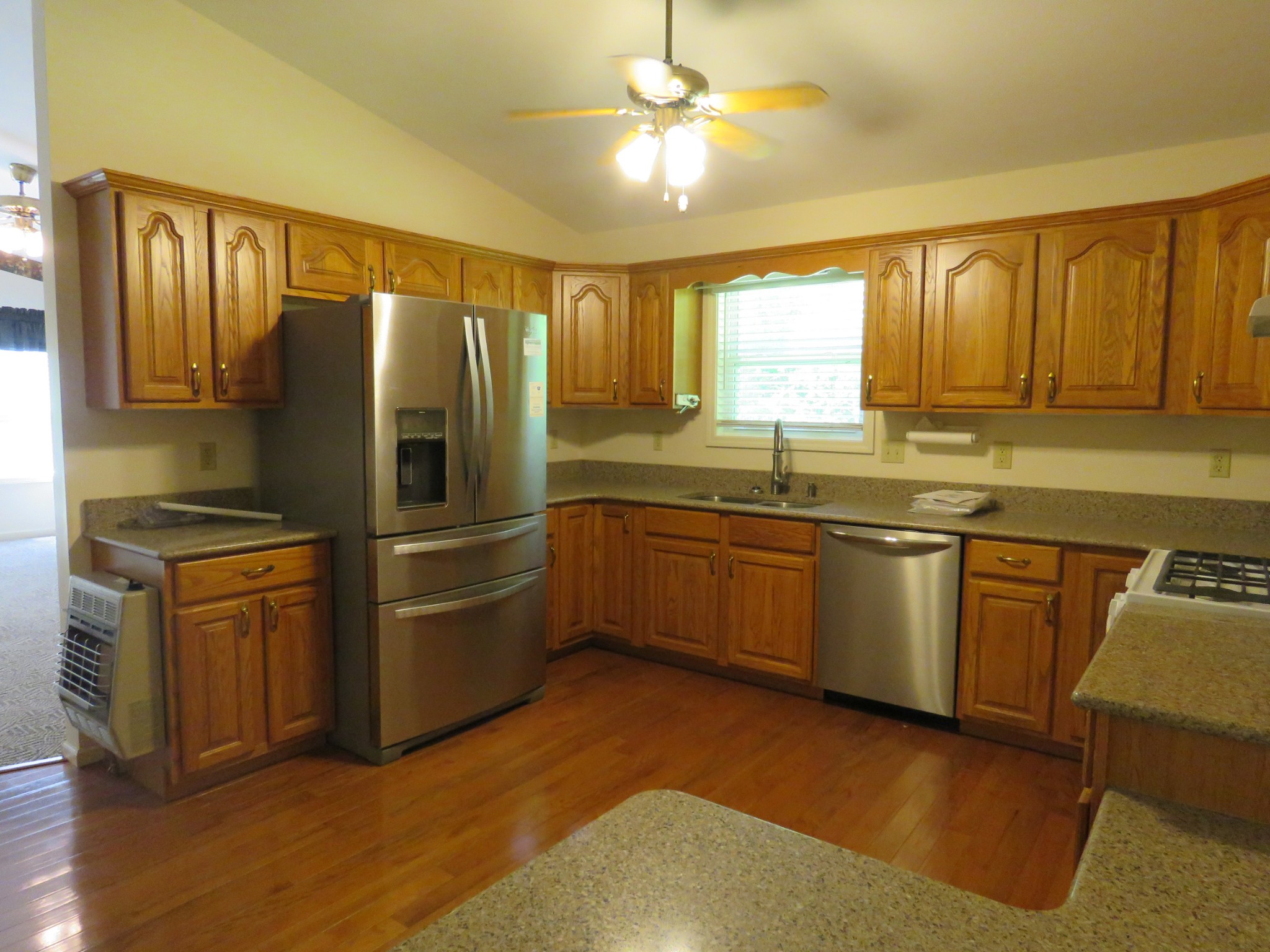 751 Yonside Drive Sparta, TN 38583 - Photo 7 of 36 a kitchen with granite countertop stainless steel appliances a sink cabinets and a window