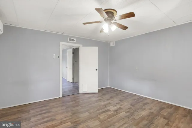 a bathroom with a sink a toilet a mirror and shower