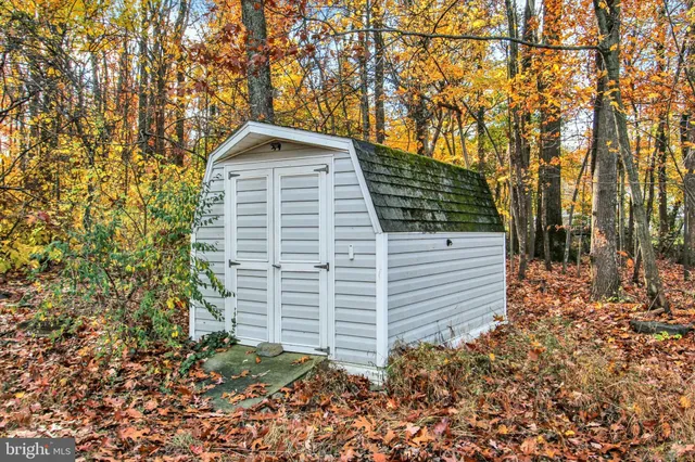 a view of a yard with wooden fence