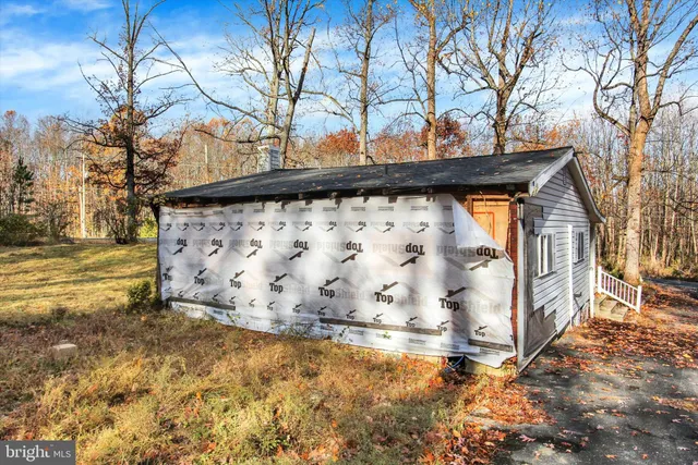 a large white house with a large tree in front of it