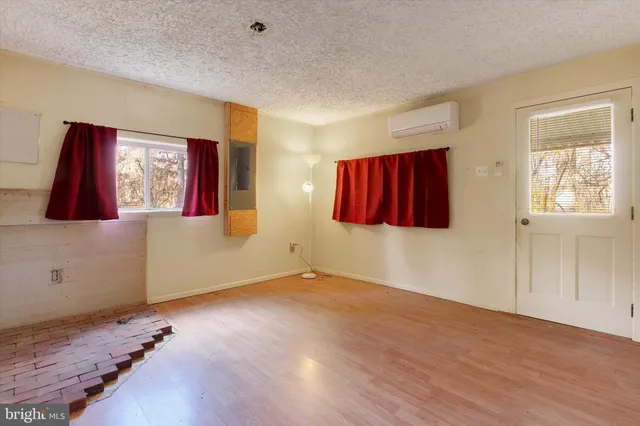 a view of a room with wooden floor and windows