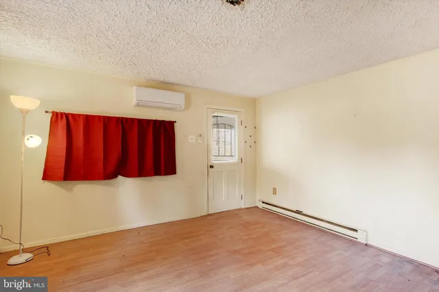 a view of a livingroom with wooden floor and cabinet