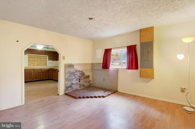 a kitchen with a sink cabinets wooden floor and stainless steel appliances
