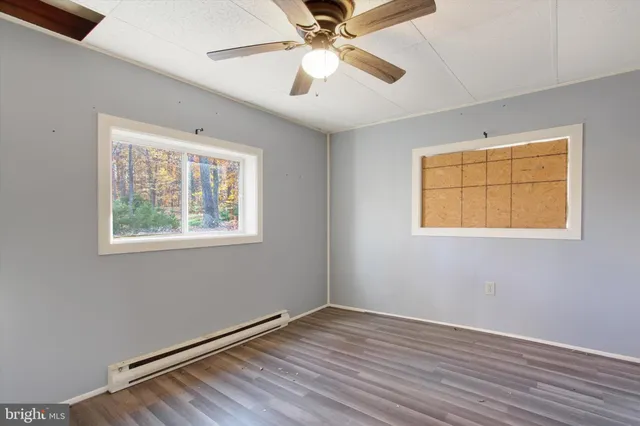a view of an empty room with wooden floor