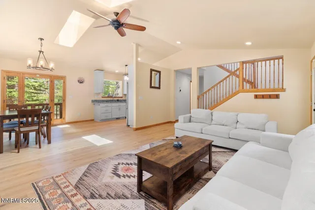 a living room with furniture and a chandelier