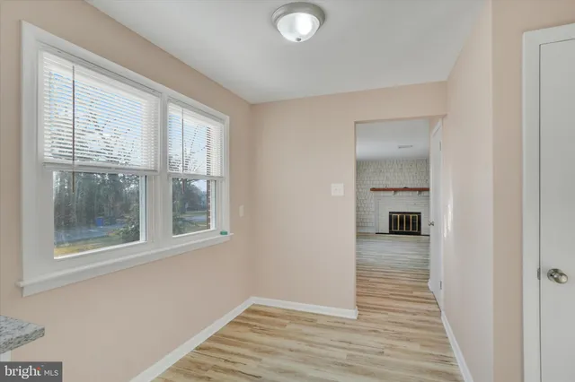 a view of a room with wooden floor and a window