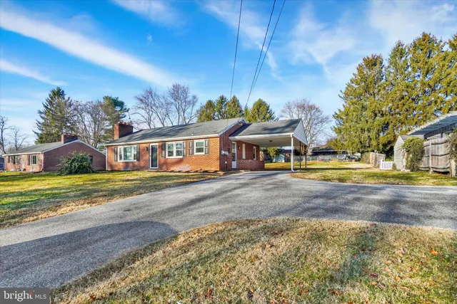 a view of a house with outdoor space and sitting area