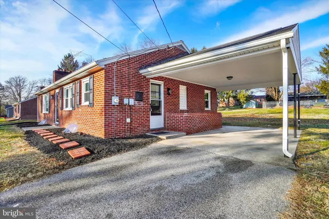a front view of a house with basket ball court