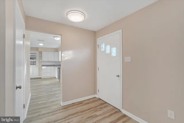 a view of a hallway with wooden floor