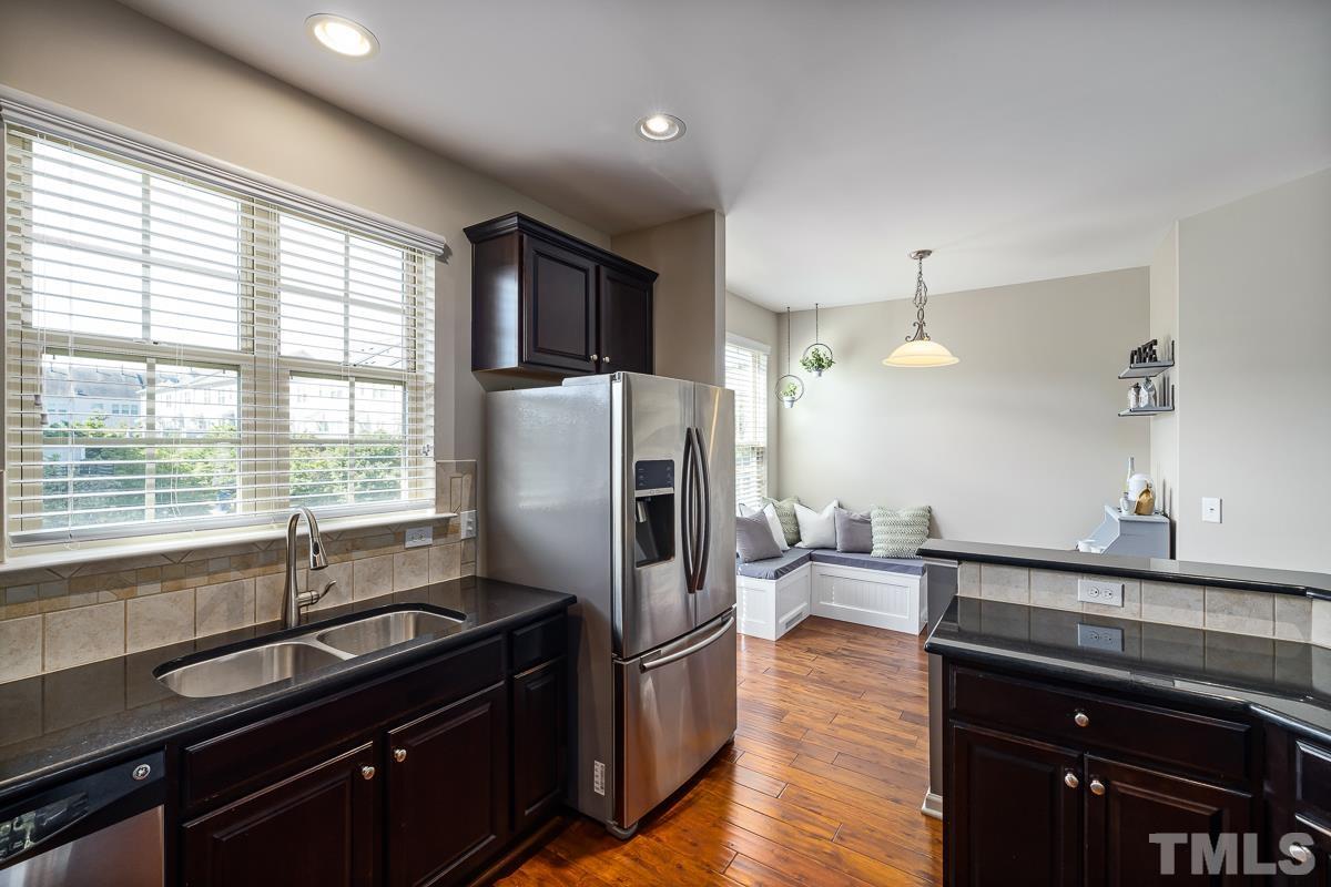 1327 Rembrandt Circle Raleigh, NC 27607 - Photo 13 of 41 a kitchen with stainless steel appliances granite countertop a sink stove and refrigerator
