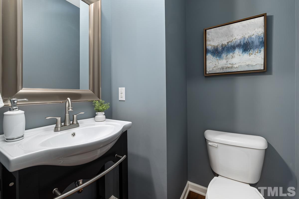 1327 Rembrandt Circle Raleigh, NC 27607 - Photo 17 of 41 a bathroom with a toilet a sink and a mirror