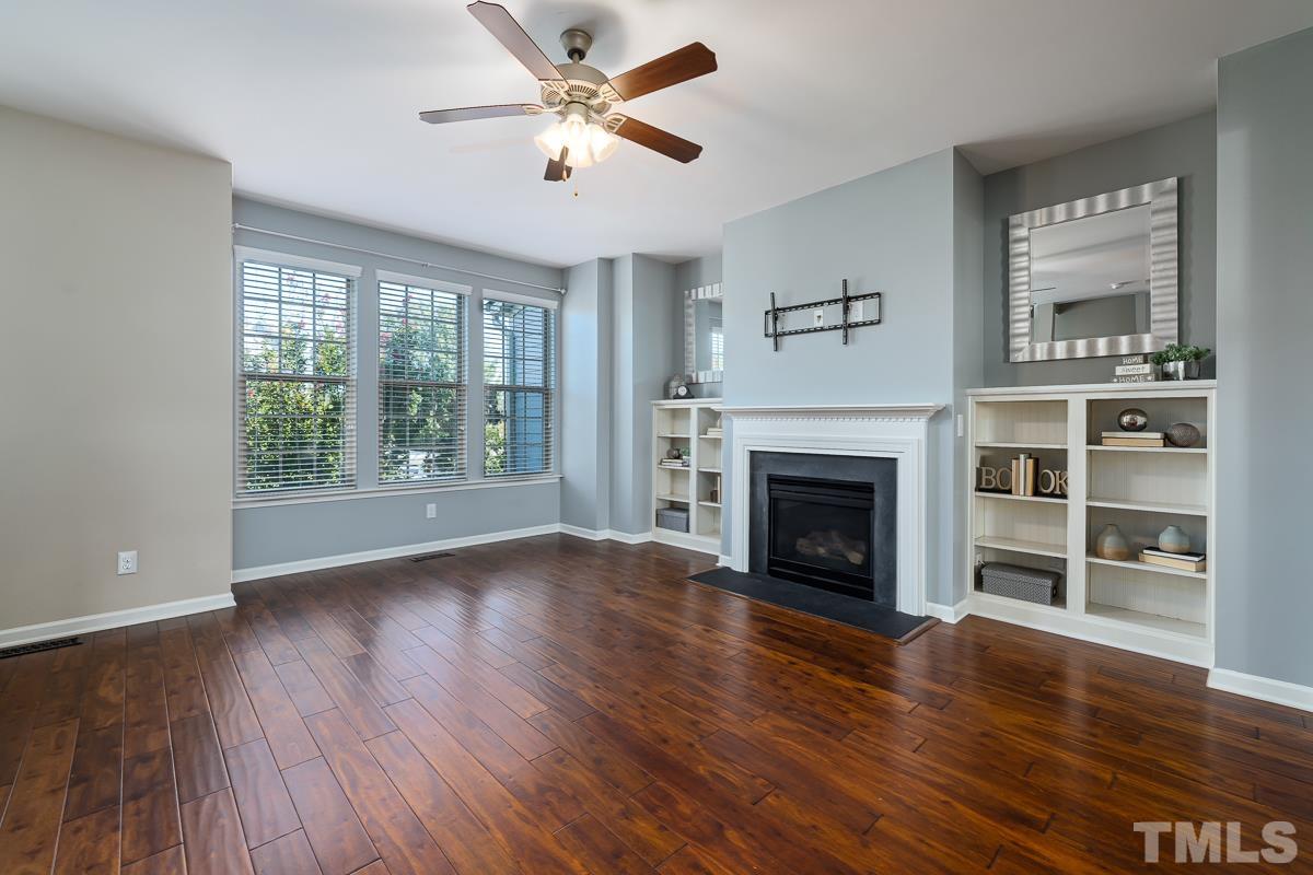 1327 Rembrandt Circle Raleigh, NC 27607 - Photo 19 of 41 a view of an empty room with wooden floor fireplace and a window