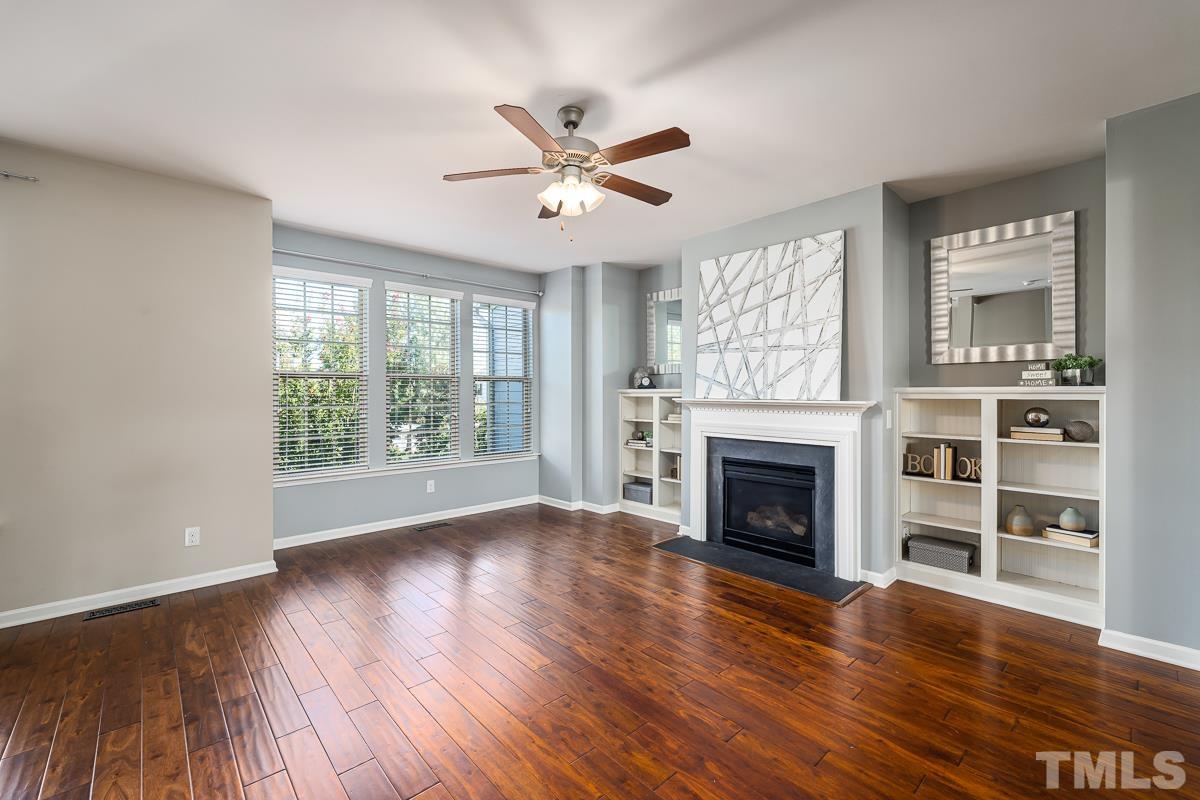 1327 Rembrandt Circle Raleigh, NC 27607 - Photo 21 of 41 a view of an empty room with wooden floor fireplace and a window