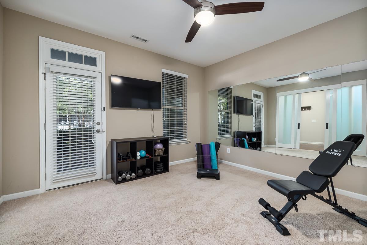 1327 Rembrandt Circle Raleigh, NC 27607 - Photo 7 of 41 a living room with furniture a fireplace and a flat screen tv