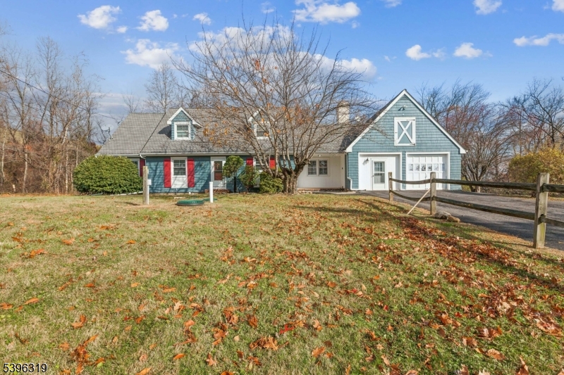 a view of house with outdoor space and sitting area