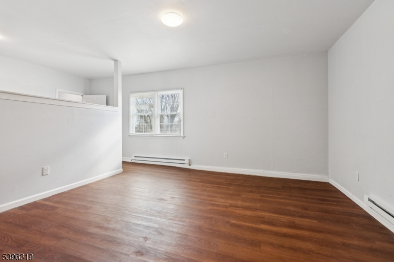 110 Old Turnpike Road Califon, NJ 07830 - Photo 14 of 25 a view of an empty room with wooden floor and a window