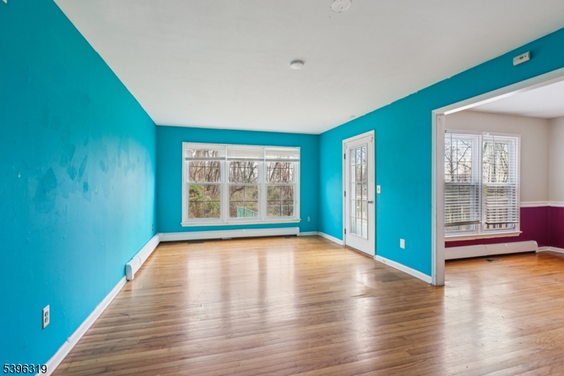110 Old Turnpike Road Califon, NJ 07830 - Photo 17 of 25 a view of an empty room with window and wooden floor