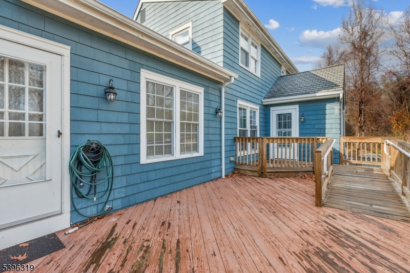110 Old Turnpike Road Califon, NJ 07830 - Photo 22 of 25 a front view of a house with a barbeque and wooden stairs