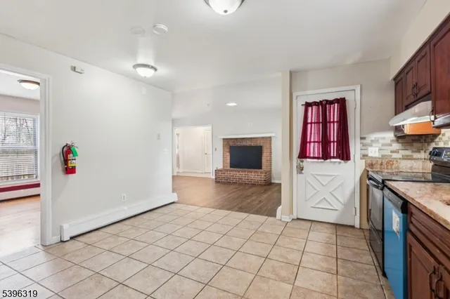 a kitchen with granite countertop a sink and a stove top oven