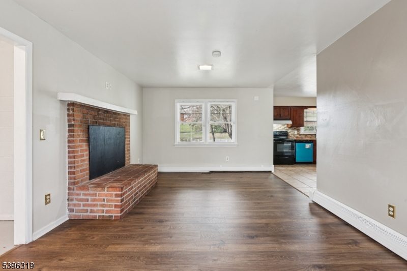 110 Old Turnpike Road Califon, NJ 07830 - Photo 5 of 25 an empty room with wooden floor cabinet and windows