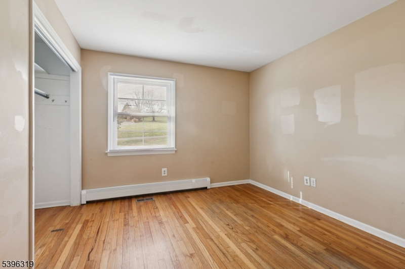 110 Old Turnpike Road Califon, NJ 07830 - Photo 8 of 25 a view of an empty room with wooden floor and a window