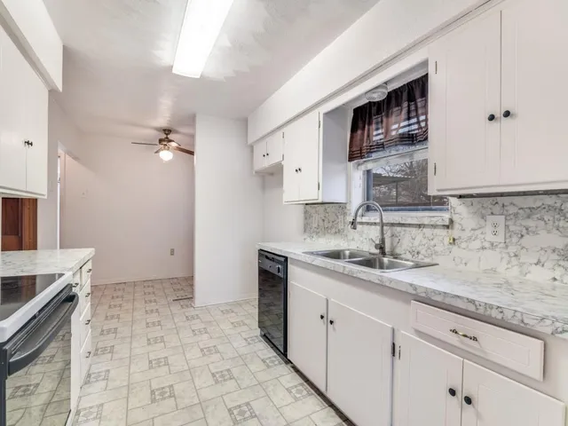 a kitchen with stainless steel appliances granite countertop a sink stove and cabinets