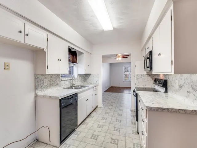 a kitchen with a sink stove and cabinets