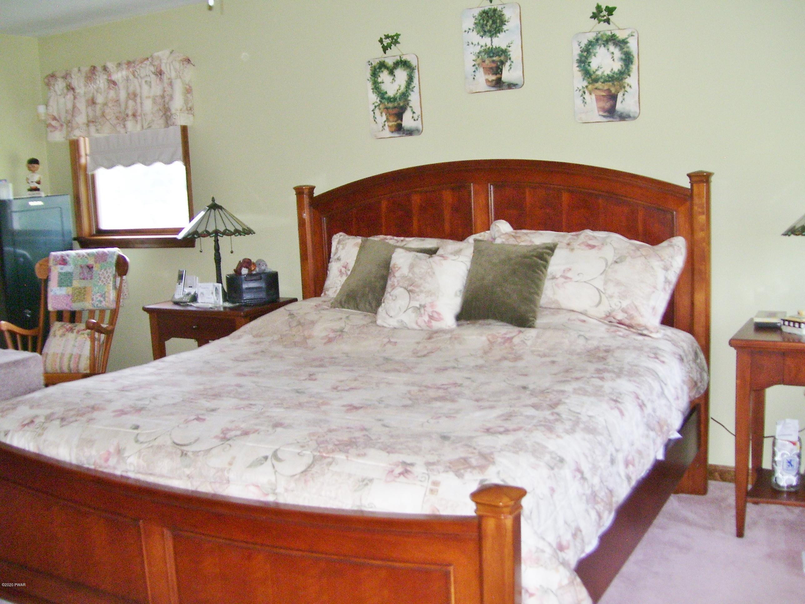50 Layton Road Waymart, PA 18472 - Photo 30 of 61 a large bed sitting in a bedroom and painting on the wall