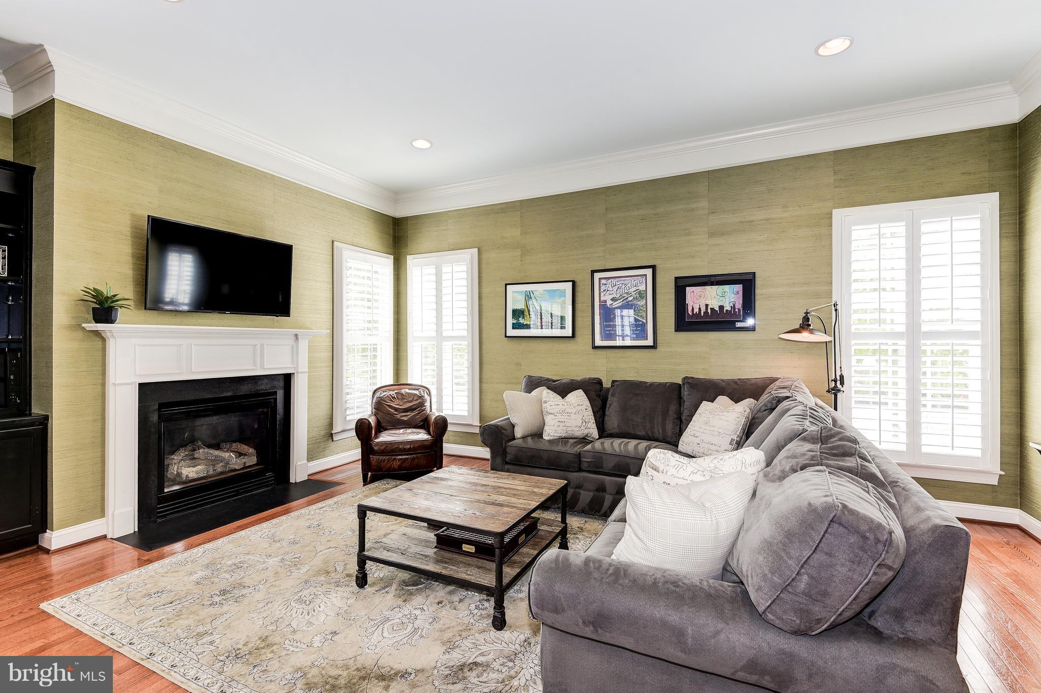 Sun drenched family room with cozy fireplace