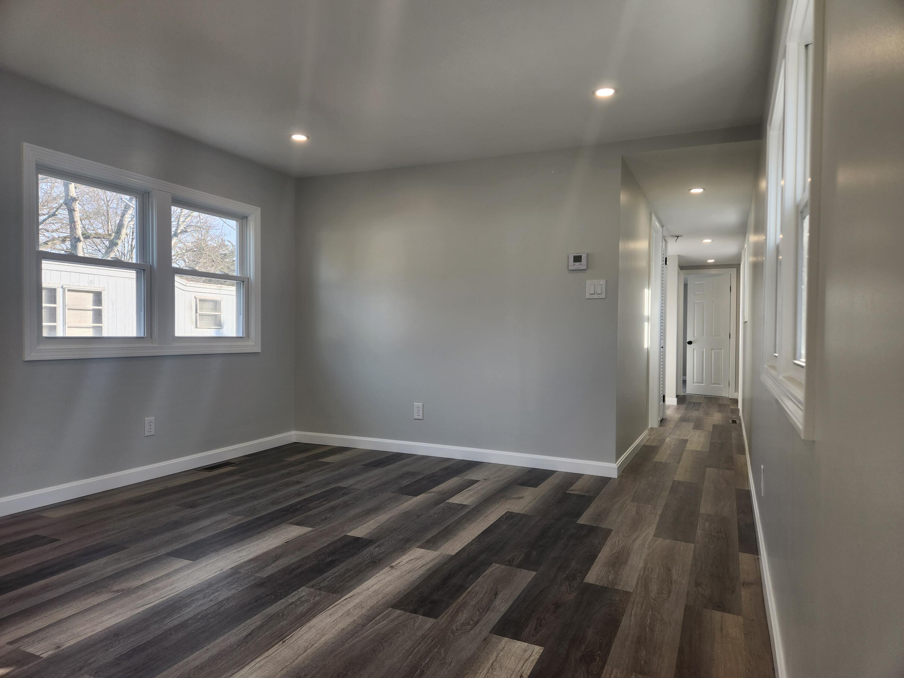 3 4th Avenue Pocasset, MA 02559 - Photo 11 of 23 an empty room with wooden floor and windows