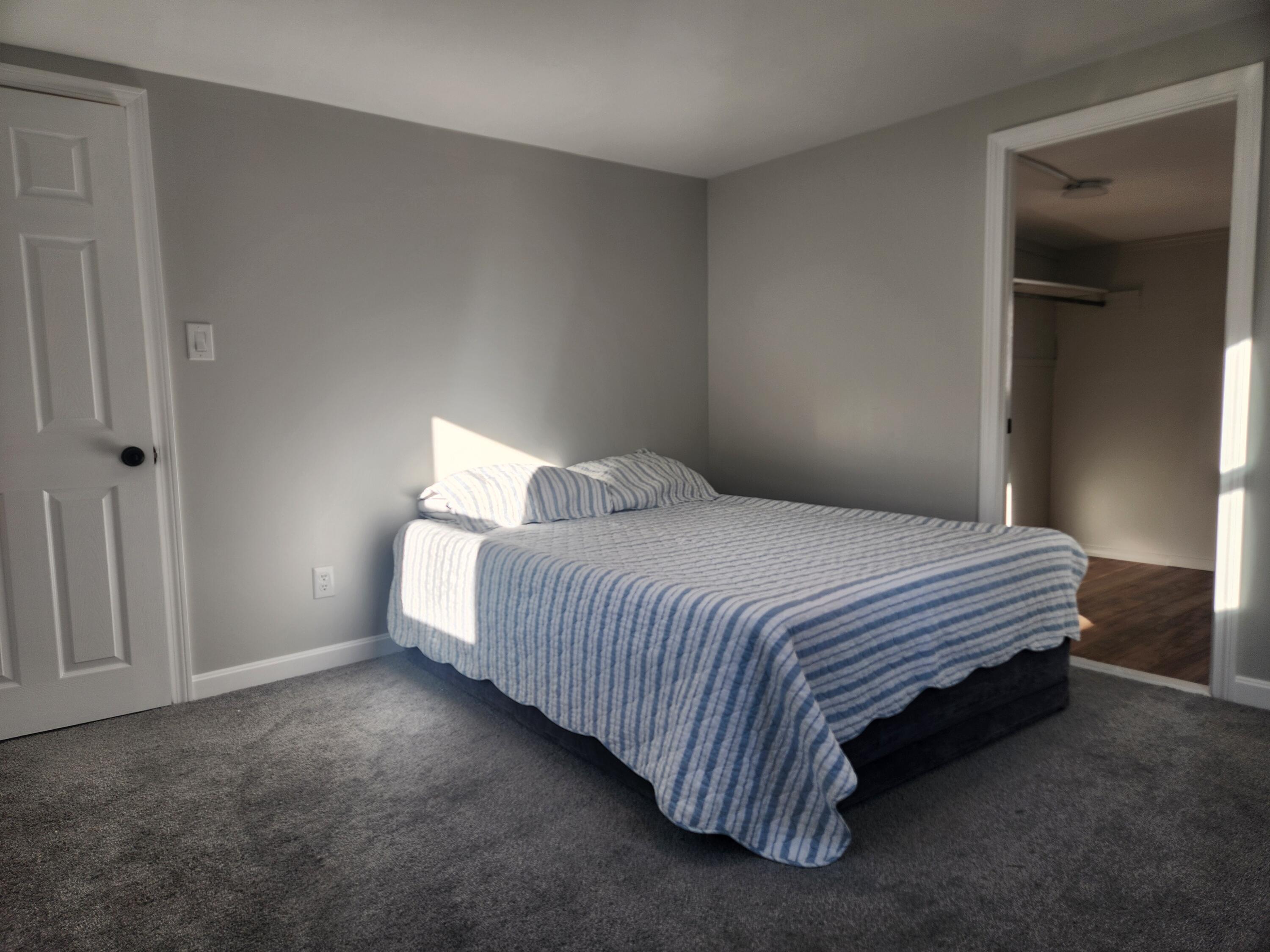 3 4th Avenue Pocasset, MA 02559 - Photo 13 of 23 a spacious bedroom with a bed and a window